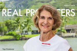Picture of Judy Sobin on the cover of Magazine Real Producers. A marina a with houses are in the background